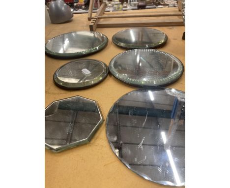 AN OVAL MIRROR WITH GLASS BEADS TOGETHER WITH SEVERAL DRESSING TABLE TRAYS 