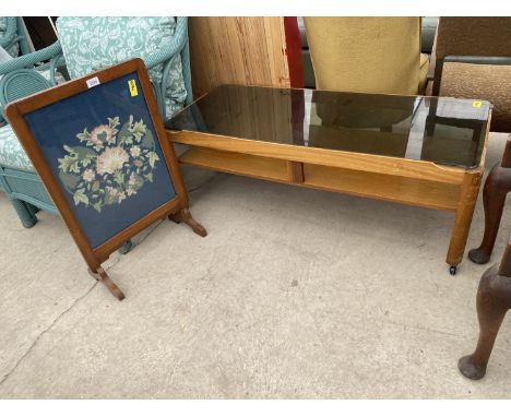 A RETRO TEAK TWO TIER COFFEE TABLE WITH SMOKE GLASS TOP, 44X19" AND A WOOLWORK FIRESCREEN 