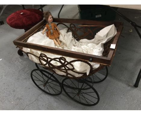 A VICTORIAN SPRUNG DOLLS PRAM MISSING HANDLE WITH CARRIAGE WHEELS TO INCLUDE A VINTAGE PORCELAIN DOLL WITH MOVING EYES MARKED