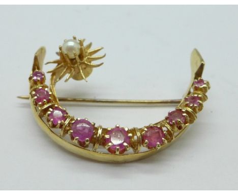 A 14ct gold, ruby and pearl crescent shaped brooch, 6.0g