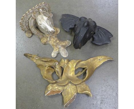 A wall bracket with horse's head and horse shoes, elephant plaque and one other, two a/f