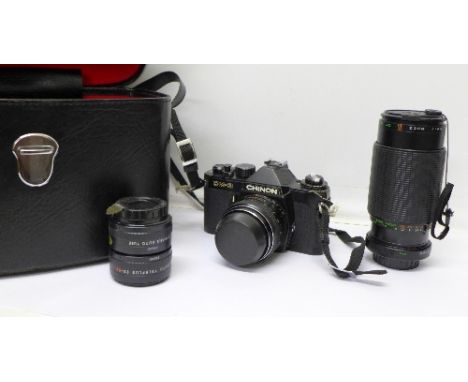 A Chinon CM-30 35mm camera with two additional lenses