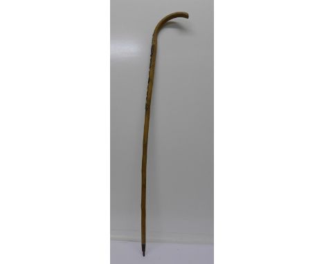 An early 20th Century walking stick with scouting badges