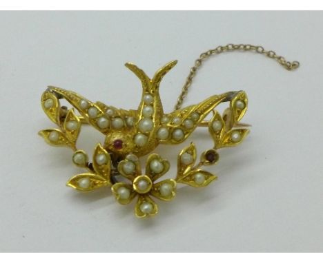 A 9ct gold, seed pearl and ruby brooch styled as a swallow, 3.3g