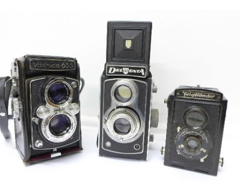 A Yashica 635 TLR camera, a Voightlander camera and a Delmonta camera