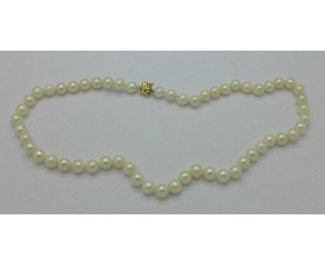 A pearl necklace with 14ct gold fastener