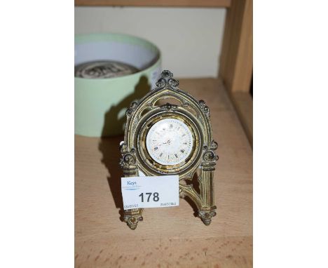SMALL BRASS EASEL BACK STAND CONTAINING A POCKET WATCH MOVEMENT