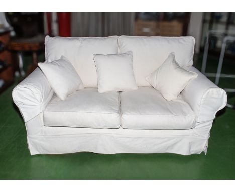 A two seater sofa with loose covers