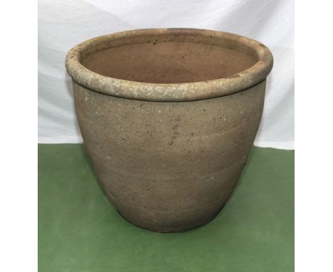 A large reconstituted stone garden planter 62cm dia. x 56cm tall