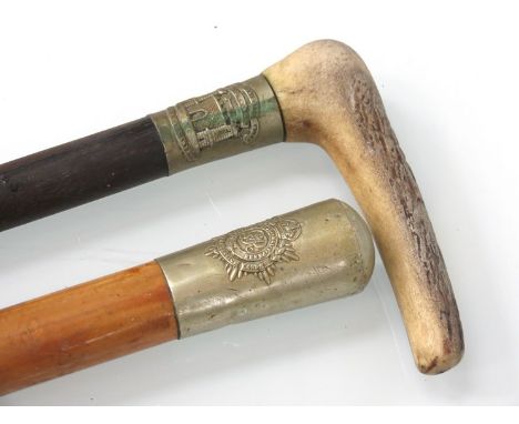 A Royal Army Service Corps knopped walking cane and a walking stick with Suffolk Regiment badge, crooked antler handle (2)