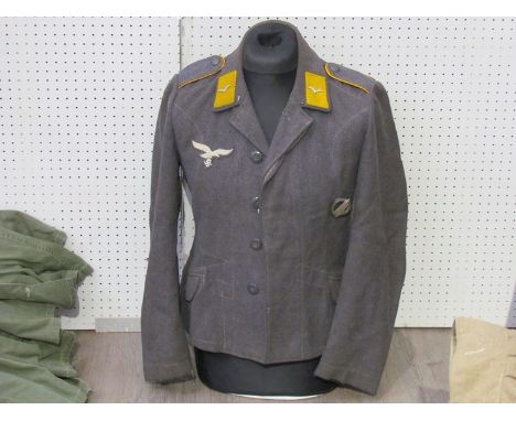 A Third Reich era German Luftwaffe Battledress blouse with Private rank (Flying) insignia to collar, together with Luftwaffe 