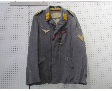 A Third Reich era German Luftwaffe blouse with Feldwebel rank (Flying) insignia to collar, together with Luftwaffe cloth eagl