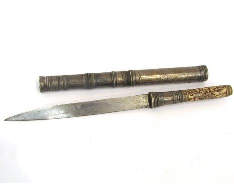 An Indian bone handled knife with carved elephant and tiger design, white metal covered scabbard