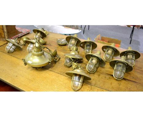 A set of early 20th century brass ships light fittings, including seven wall scones, five ceiling lights and a bulk head ligh