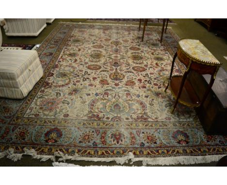 Tabriz Carpet, Iranian Azerbaijan, the ivory field of scrolling vines and polychrome palmettes enclosed by meandering vine bo