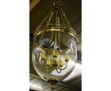 A modern brass framed and glazed circular section pendant light fitting, approx 122cm high (small chip approx 4cm to the rim)