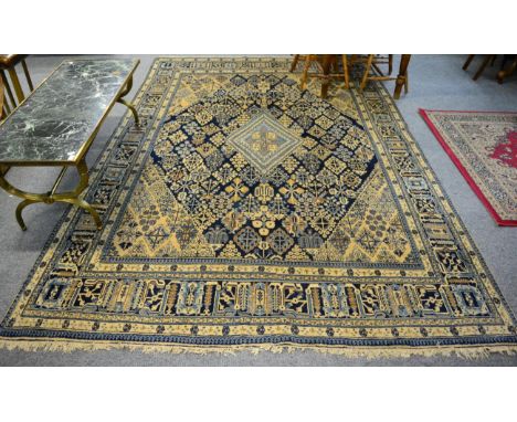 Carpet of Joshaghan design, probably Tabriz, the deep indigo lattice field of stylised plants around a sky blue medallion fra