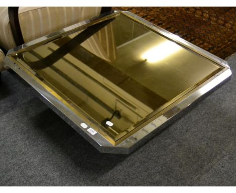 A vintage Liberty stainless steel and brass coffee table, of square form with canted corners and smokey coloured bevelled gla