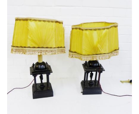 A pair of black hardstone table lamp bases, each with classical figure within a quartet of Corinthian columns complete with y