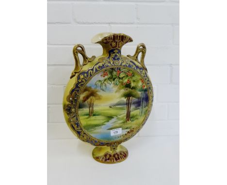 A Staffordshire twin handled pottery moon flask with a landscape painted scene to front and rose sprays to the back, 42cm hig