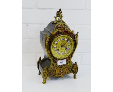 A French boule work mantle clock, the dial with Roman numerals and inscribed 'Paris', 32cm high