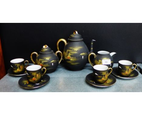 A Japanese porcelain black glazed teaset with 'Mount Fuji' pattern comprising teapot, sugar bowl, milk jug, twelve cups and t