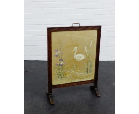 An oak framed fire screen, with an embroidered panel insert, 73 x 52cm