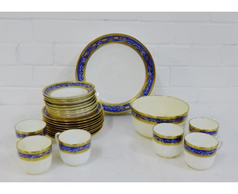 A Minton's white glazed teaset with blue and white rims with gilt highlights, comprising seven cups, ten side plates, eight s