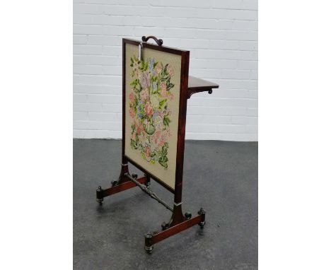 A rosewood framed fire screen fitted with a folding shelf to the back, with a needlework panel insert,  95 x 49cm 