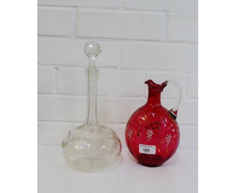 A Globe & Shaft vine etched decanter and stopper, together with a cranberry glass jug, (2) 