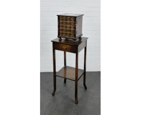 An early 20th century oak smokers cabinet, modelled in the form of a small bookcase, with silver presentation plaque to top, 