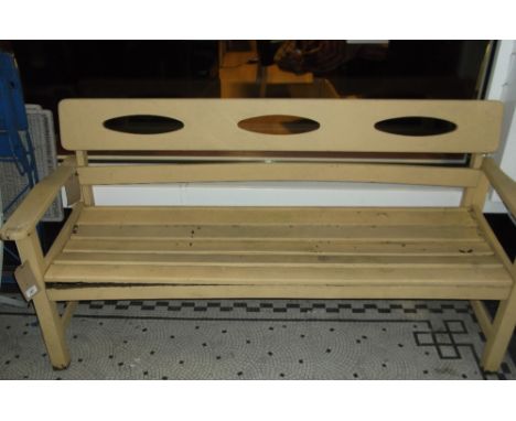 A cream painted garden bench, the rear slat with pierced decoration, W. 156cm.