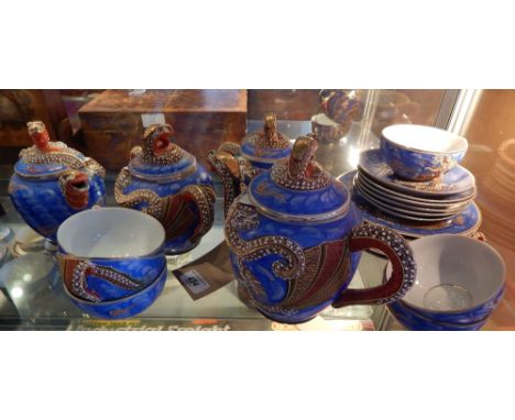 A Japanese eggshell ware tea service, extensively decorated with dragons on a sky blue ground, incorporating a lithopane.