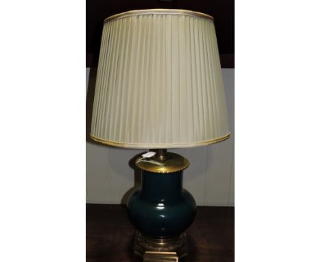 A gilt metal mounted turquoise pottery baluster table lamp on octagonal foot.