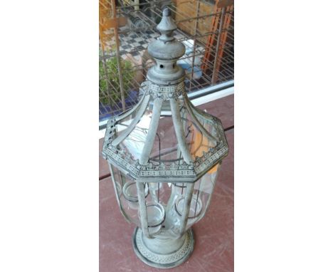 A verdigris tulip shaped garden light, of faceted form, the interior fitted with five tea-lights, H. 72cm.