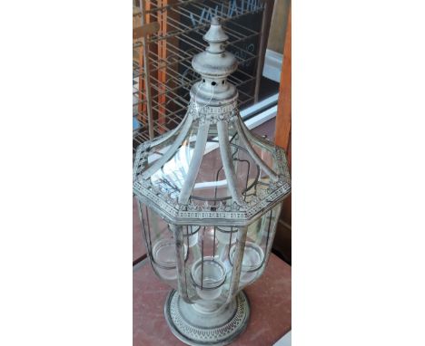 A verdigris tulip shaped garden light, of faceted form, the interior fitted with five tea-lights, H. 72cm.