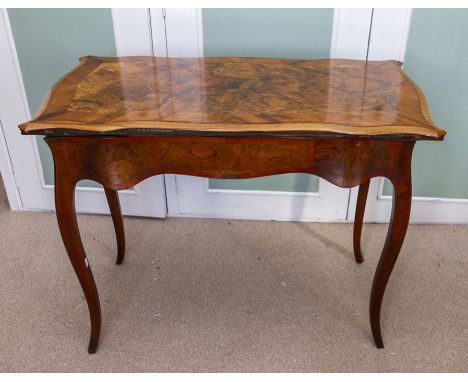 A late 19th Century walnut card table, crossbanded in yew-wood, the fold-over top with undulating border, on cabriole legs 