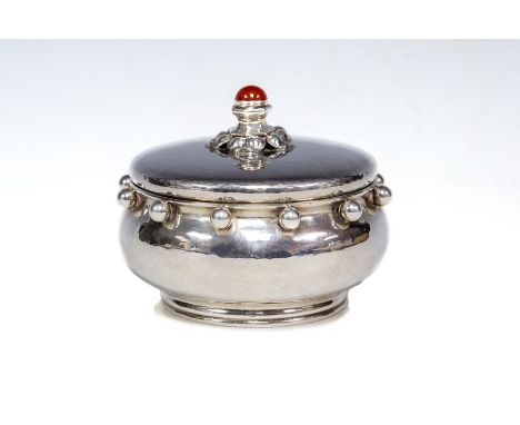 Omar Ramsden: An Arts &amp; Crafts silver bowl and cover, the spot hammered bulbous body with&nbsp; rim&nbsp;applied with lar