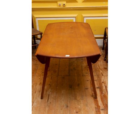 An Ercol light elm and ash dropleaf dining table,&nbsp;circular form on tapered legs, 113cm diameter, 72cm high