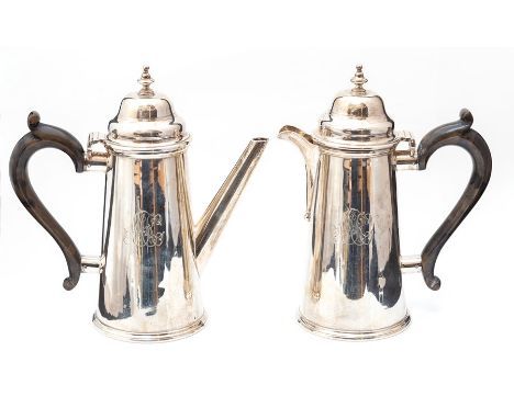 A George V plain silver coffee/chocolate pot and a matching hot water jug, engraved with monograms with domed covers, wooden 