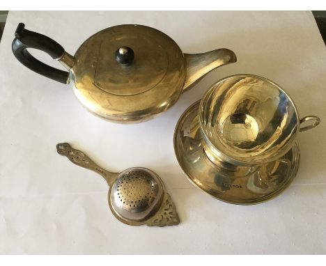 An Edwardian silver novelty tea cup and saucer, R F Mosley &amp; Co, Sheffield, 1911 together with squab teapot with ebony fi