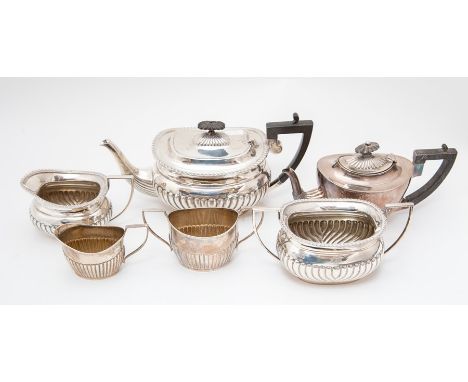 An Edwardian silver three piece tea service comprising teapot, sugar bowl and milk jug with gadroon border above gadroon lowe