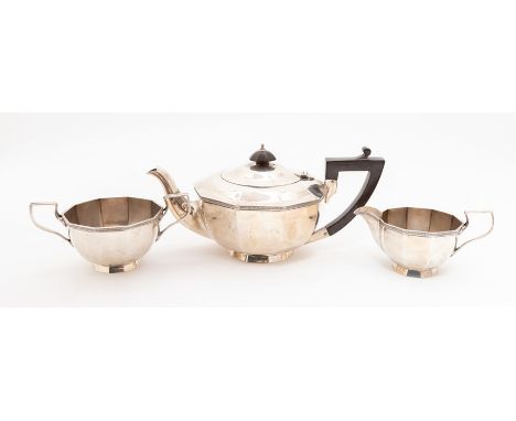 A matched Art Deco three piece plain silver tea service comprising teapot, sugar bowl and milk jug, chevron border above face