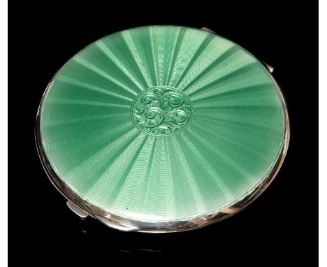 An Elizabeth II silver and green enamel compact, the cover with enamel radial striped and floral centre, engine turned back, 