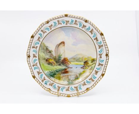 A Derby King Street marked plate, painted by W E J Dean with Ilam Rock, Derbyshire, signed, 22cm diameter