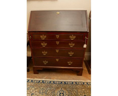 A George III mahogany bureau, circa 1780, the fall front opening to reveal a fitted interior, the base with four long graduat