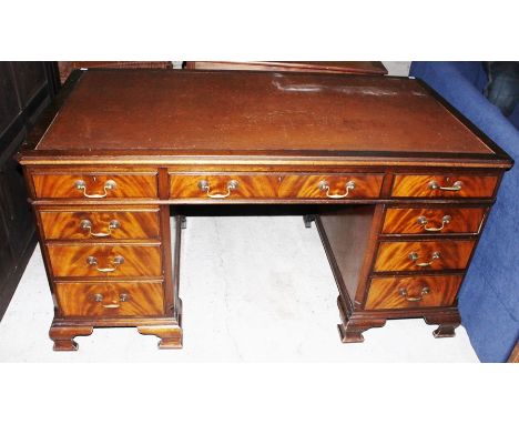 A Waring and Gillow mahogany leather inset twin pedestal writing desk, the top with a long central drawer and two short drawe