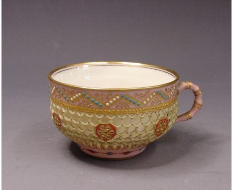 A Royal Worcester reticulated tea cup in the manner of George Owen, double walled with a honeycomb and jewelled exterior and 