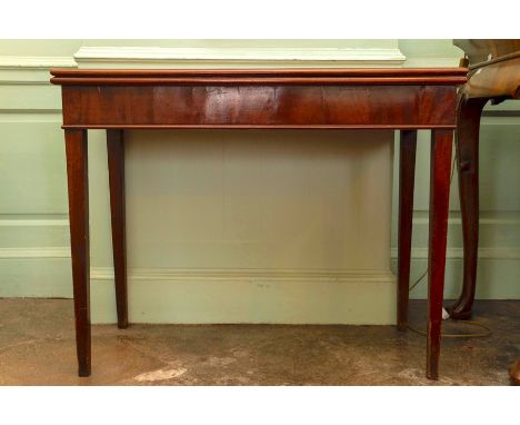 A George III mahogany fold over card table, standing&nbsp;on square legs