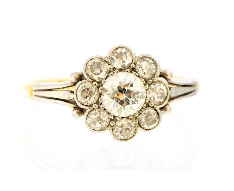 An Edwardian diamond flower head cluster 18ct gold ring, with seven round old cut diamonds, the central diamond approx 0.50ct